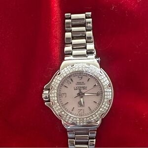 Tag Women's formula Watch with diamonds and unique pink pearl face.